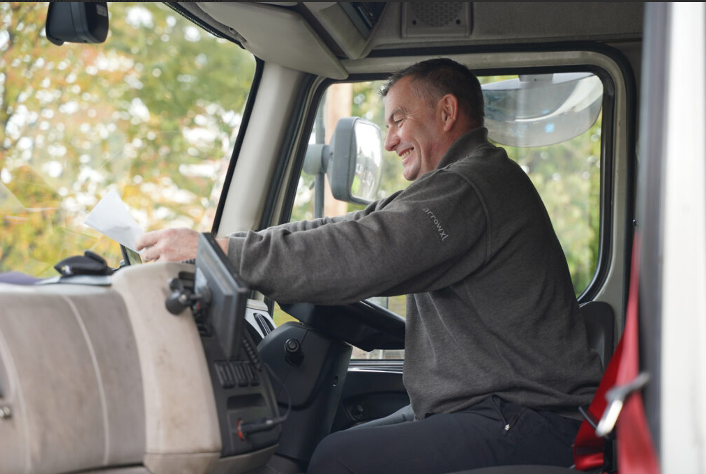 A person smiling in a truckAI-generated content may be incorrect.