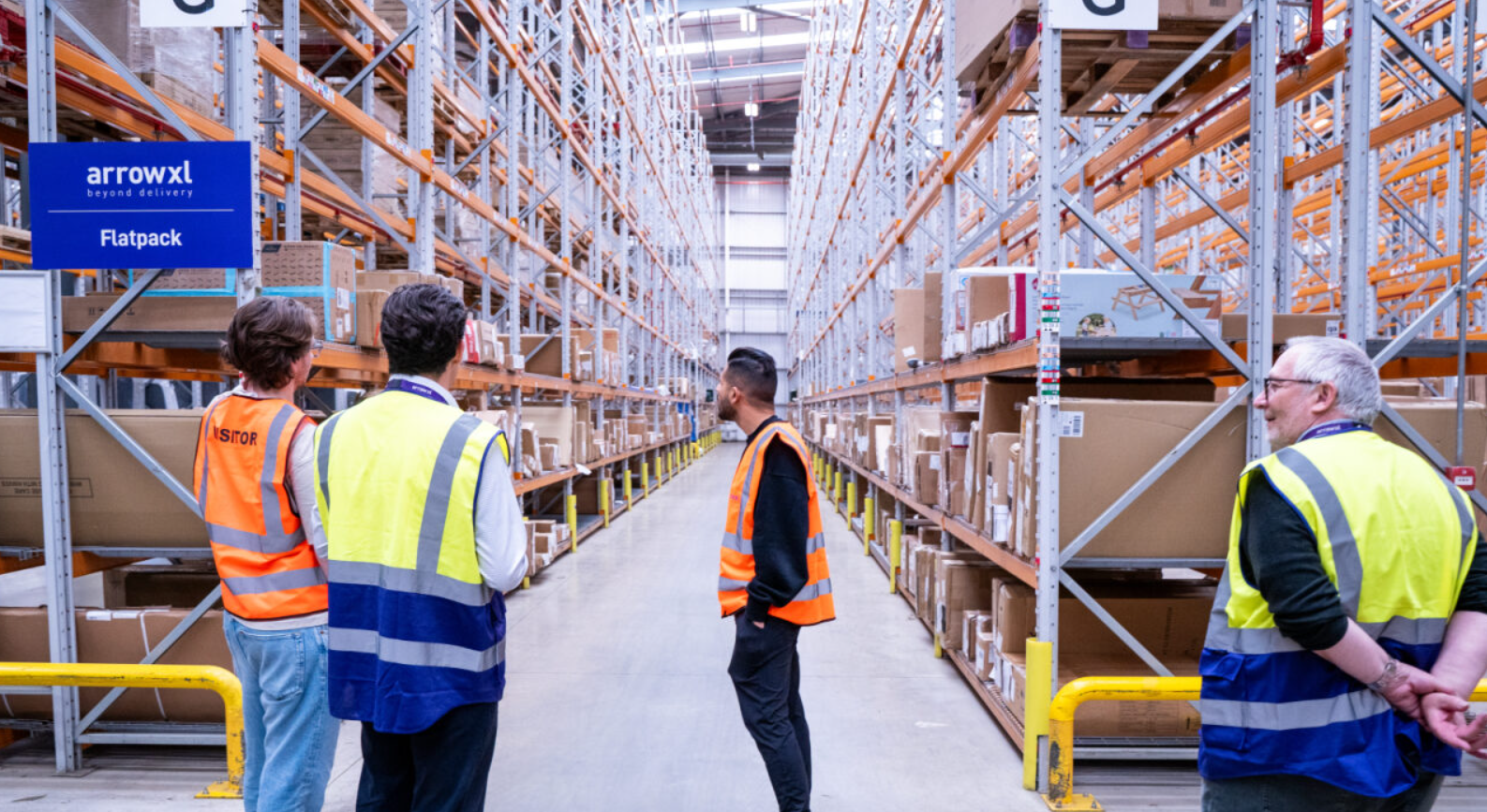 A group of men in a warehouseAI-generated content may be incorrect.