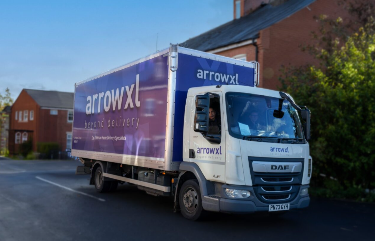 A white truck with purple and white text on itAI-generated content may be incorrect.