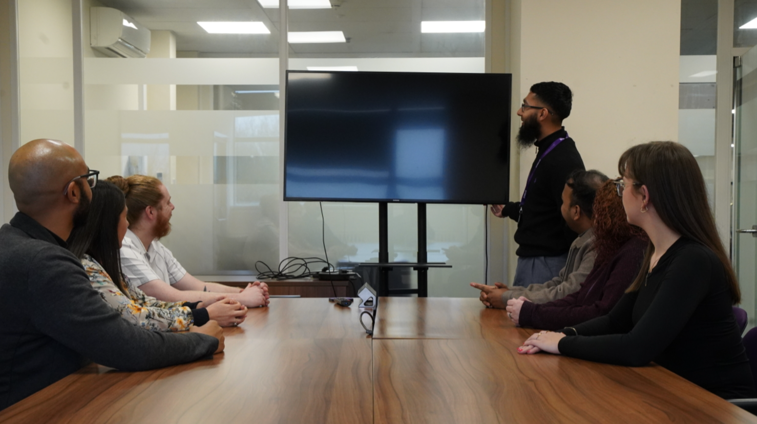 A person standing in front of a large screenAI-generated content may be incorrect.