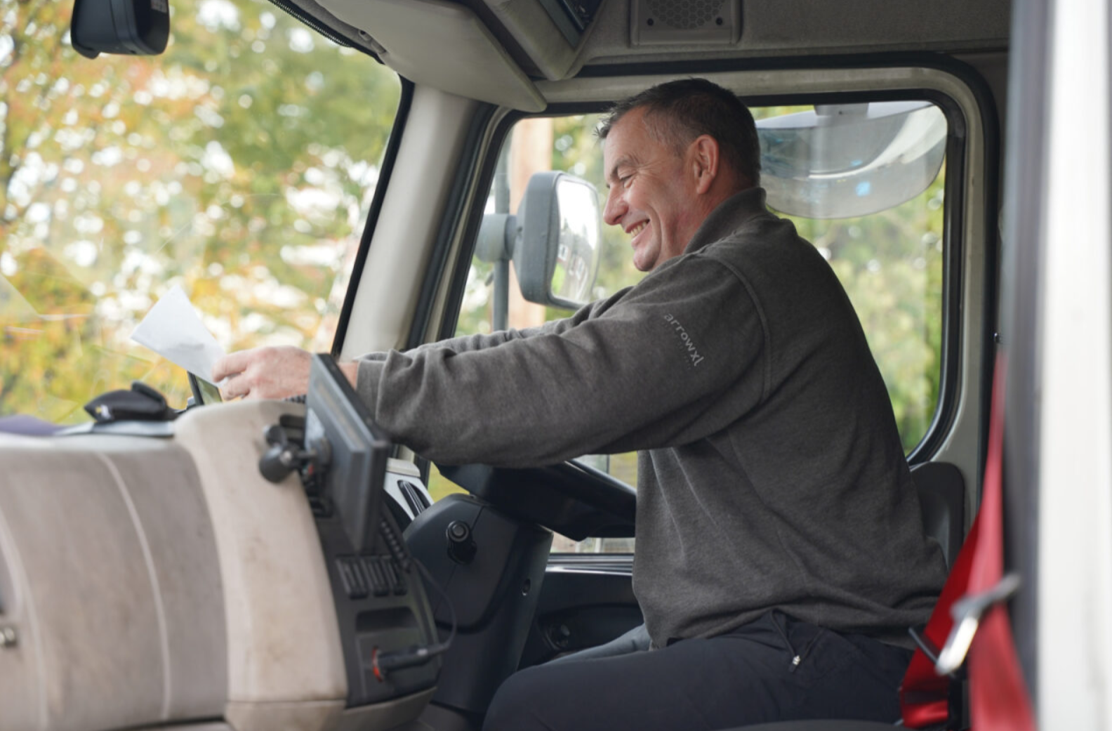 A person driving a truckAI-generated content may be incorrect.